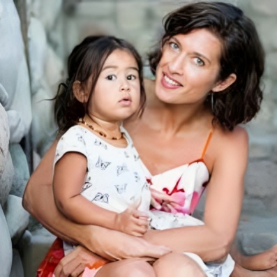 Matewa Kiritapu sitting in the lap of her mother, Chelsea Winstanley.